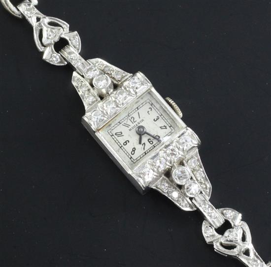 A ladys 20th century platinum and diamond set Monarch manual wind cocktail watch, on a 14ct white gold bracelet, 6.25in.